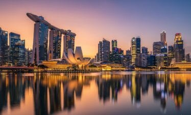 Futuristic Marina Bay Sands and Singapore skyline at golden hour with vibrant city lights