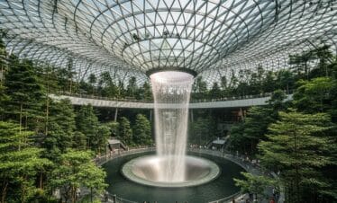 Modern and eco-friendly design of Changi Airport in Singapore with Rain Vortex and indoor greenery